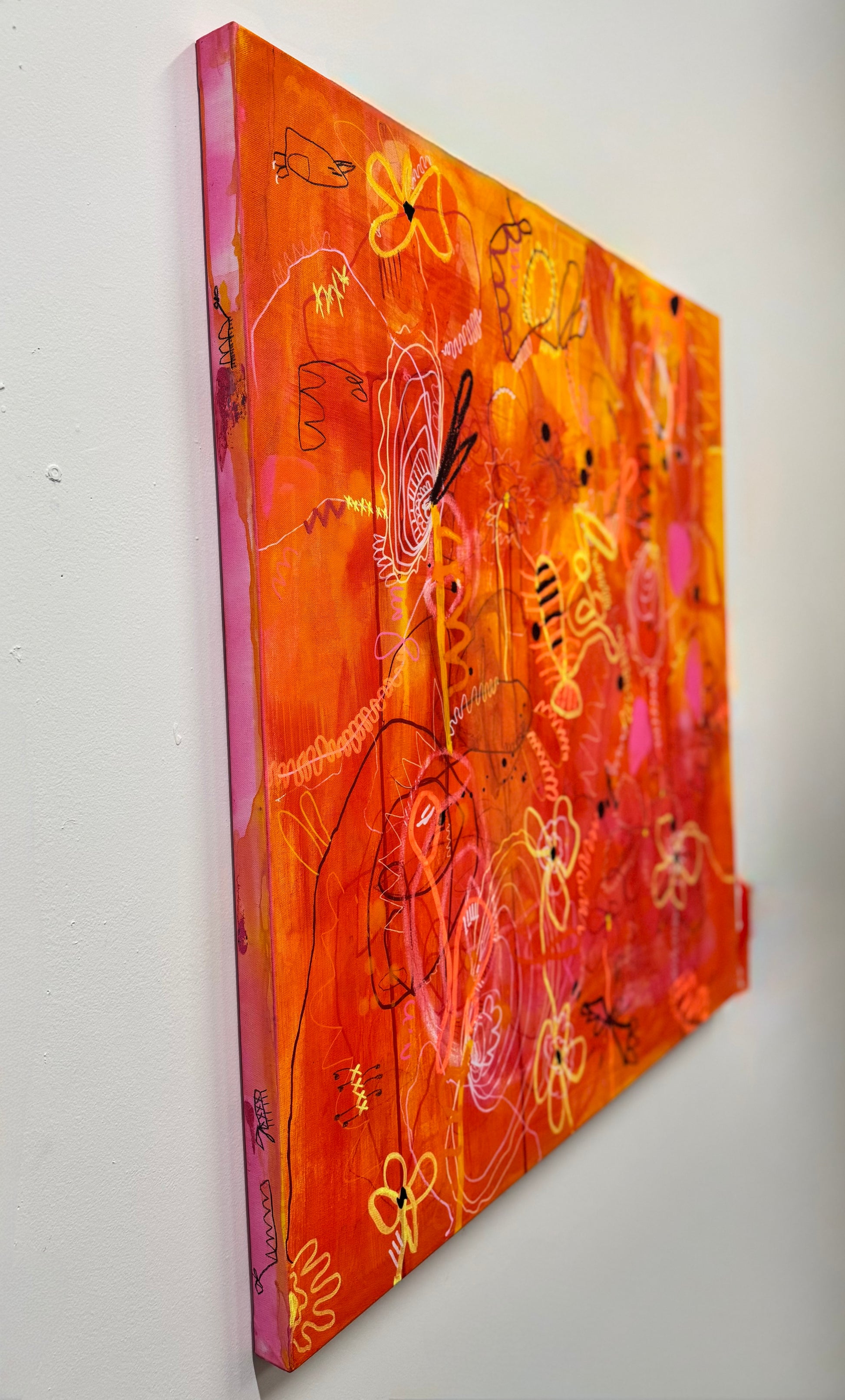 Side shot of a bright, colorful abstract painting titled "She's Still In There" by Marisa Gouda, capturing childhood wonder.